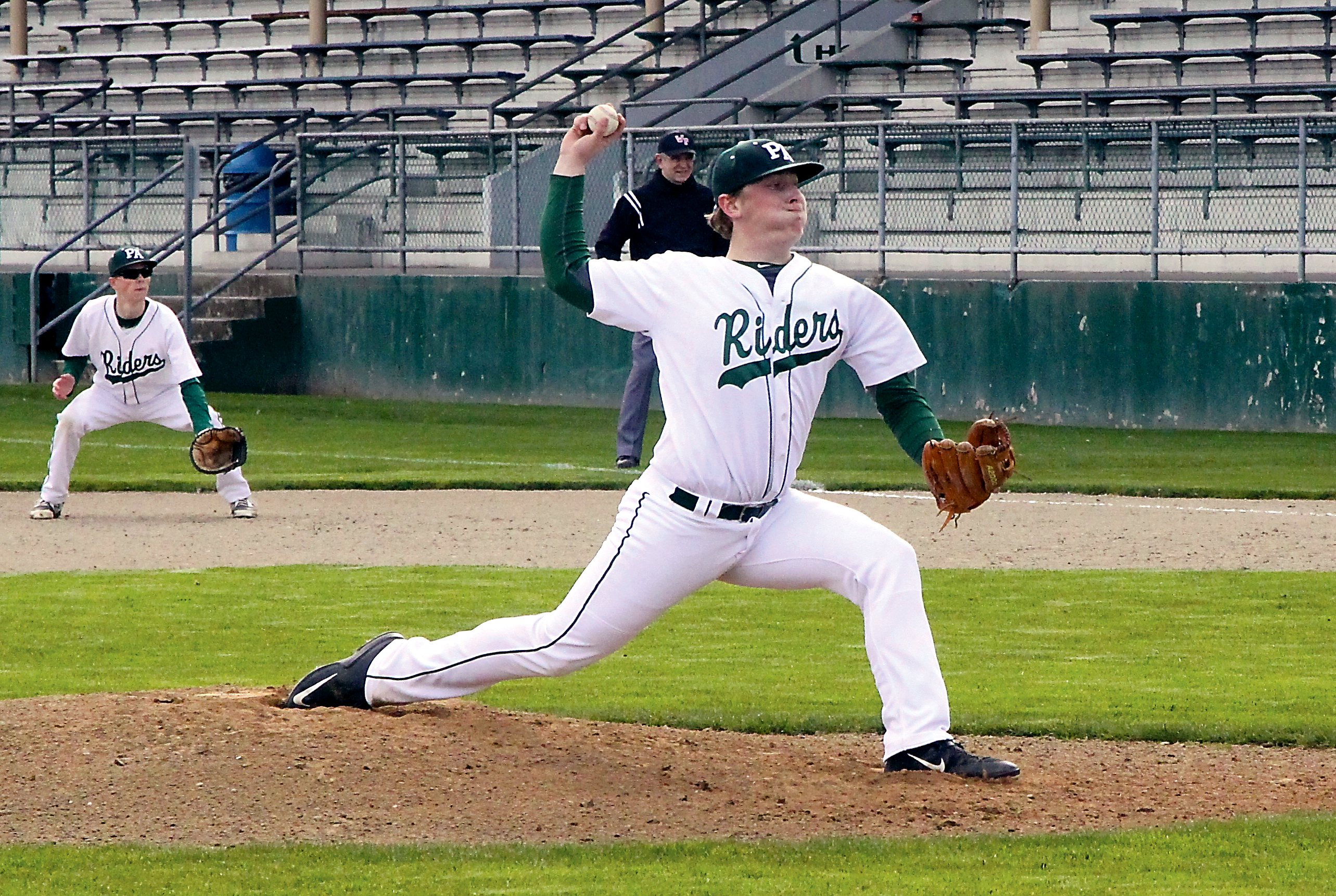 Port Angeles' Travis Paynter prepares to throw a pitch during the Roughriders' 4-2 over Sequim at Civic Field. Paynter pitched a complete-game 4-hitter