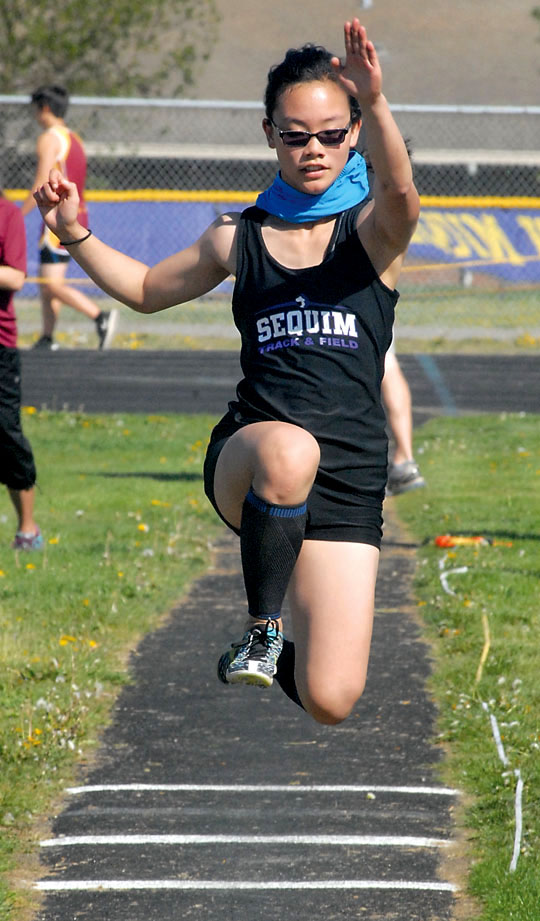 Sequim's Elizabeth Sweet competes in the triple jump during a meet with Kingston and Klahowya at Sequim High School. Sweet finished second in the triple jump. (Keith Thorpe/Peninsula Daily News)