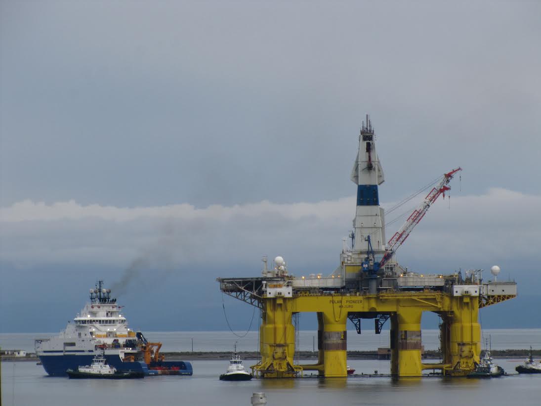 The Polar Pioneer oil rig is towed by tugs in Port Angeles Harbor on Sunday morning after being offloaded from the MV Blue Marlin. (Arwyn Rice/Peninsula Daily News)