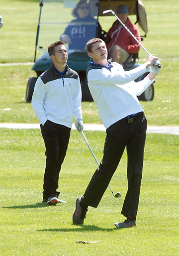 James Porter of Chimacum takes his team's second shot on the first hole while teammate Chris Bainbridge looks on. The pair shot a round of 2-under-par 70 to finish tied for third. (Keith Thorpe/Peninsula Daily News)