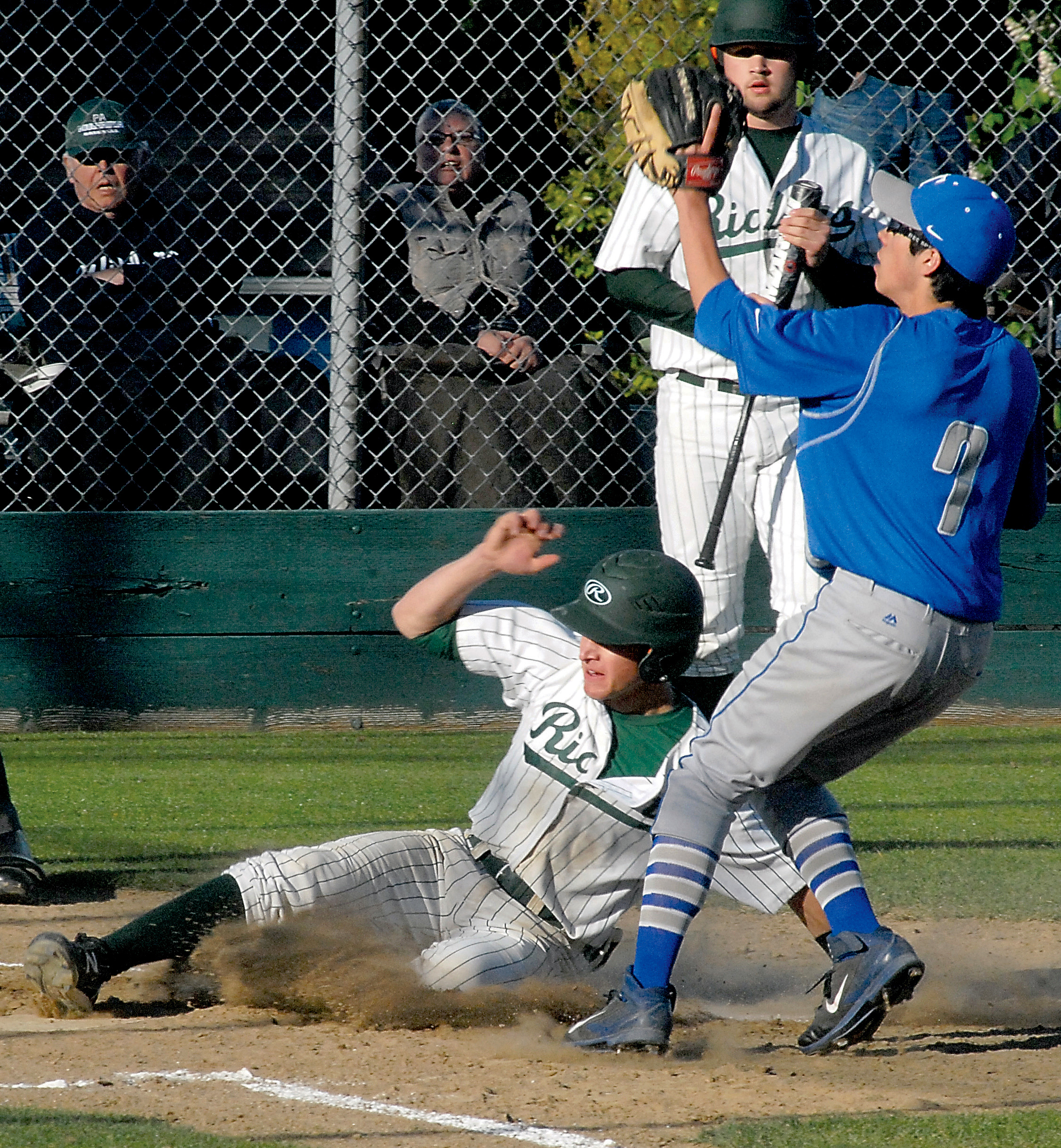 Port Angeles' Logan Ciaciuch steals home while Olympic pitcher Ryan Huddleston