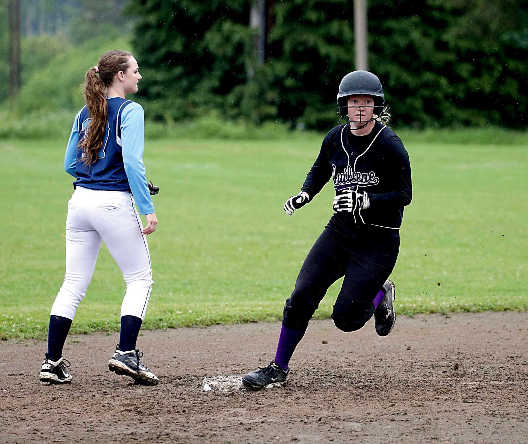 Quilcene's Katie Bailey rounds second base on her way to a stand-up triple against Rainier Christian. (Steve Mullensky/for Peninsula Daily News)