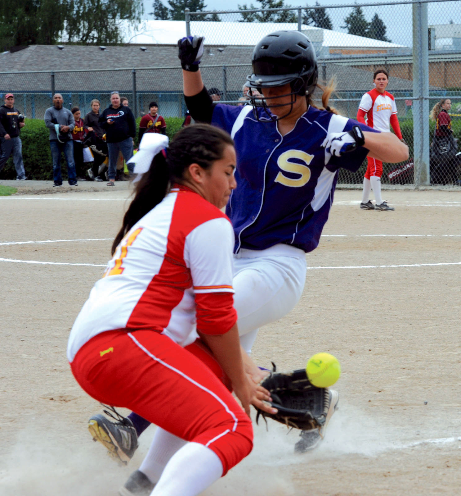 Sequim's Olivia Kirsch gets back to third base safely while Steilacoom's Lauren Onasai gathers the throw during the Wolves' 7-4 win at the district tournament. (Lonnie Archibald/for Peninsula Daily News)