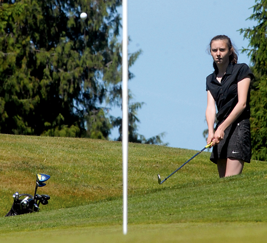 Sequim's Alex McMenamin makes a chip shot to the green on the 11th hole during the Olympic League Championships at The Cedars of Dungeness earlier this month. (Keith Thorpe/Peninsula Daily News)