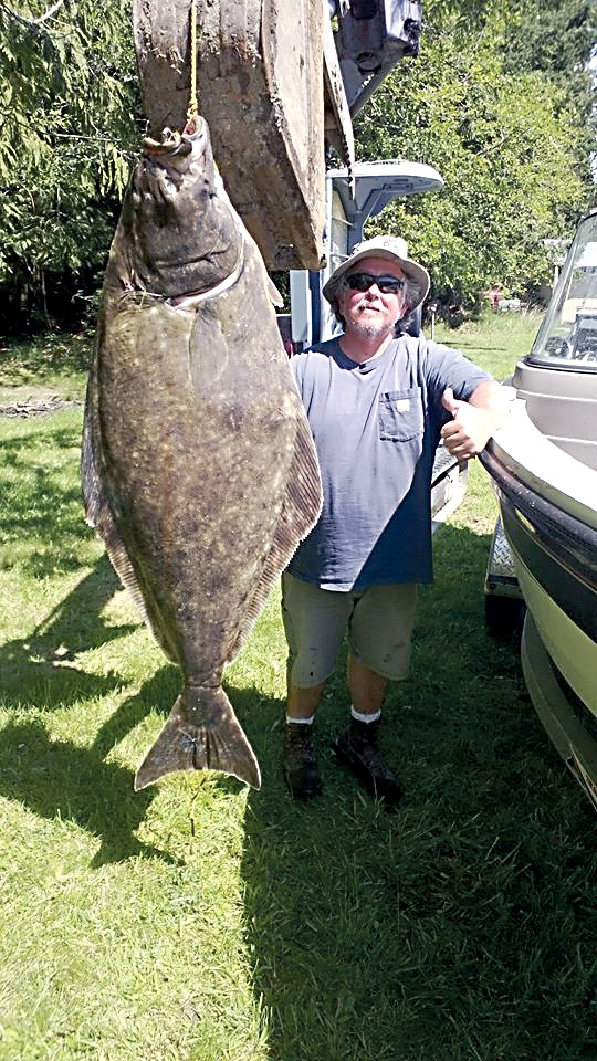 Ben Pacheco of Joyce caught this 110-pound halibut in 76 feet of water at Green Point east of Port Angeles. (Donna Pacheco)