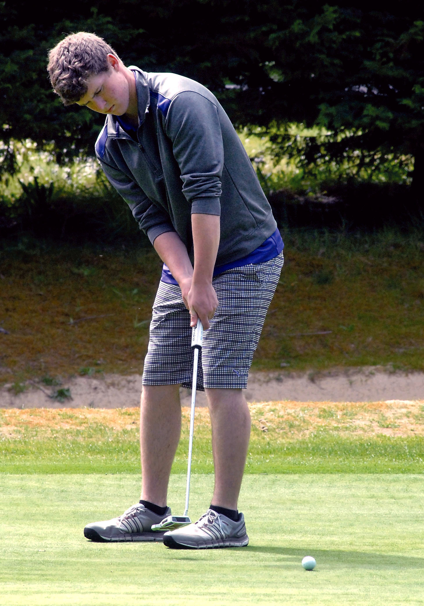 Jack Shea of Sequim putts during the Duke Streeter Invitational at Peninsula Golf Club in Port Angeles earlier this month. Shea begins the Class 2A state tournament at 7:30 a.m. today at Liberty Lake Golf Course. (Keith Thorpe/Peninsula Daily News)