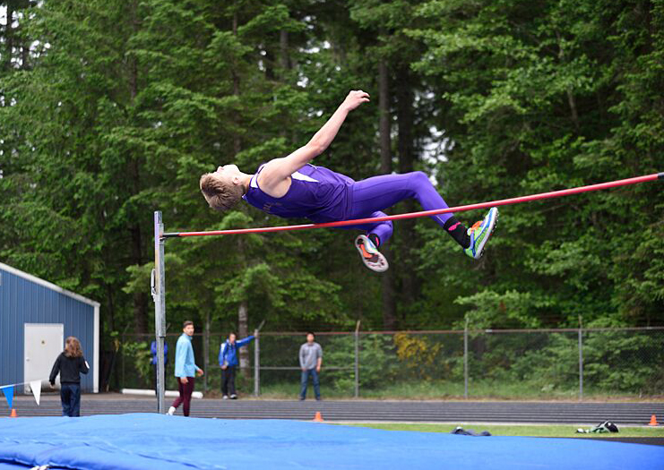 Sequim's Jackson Oliver clears the bar in the high jump during the District 2/3 championship meet at North Mason High School. (Dave Shreffler/for Peninsula Daily News)
