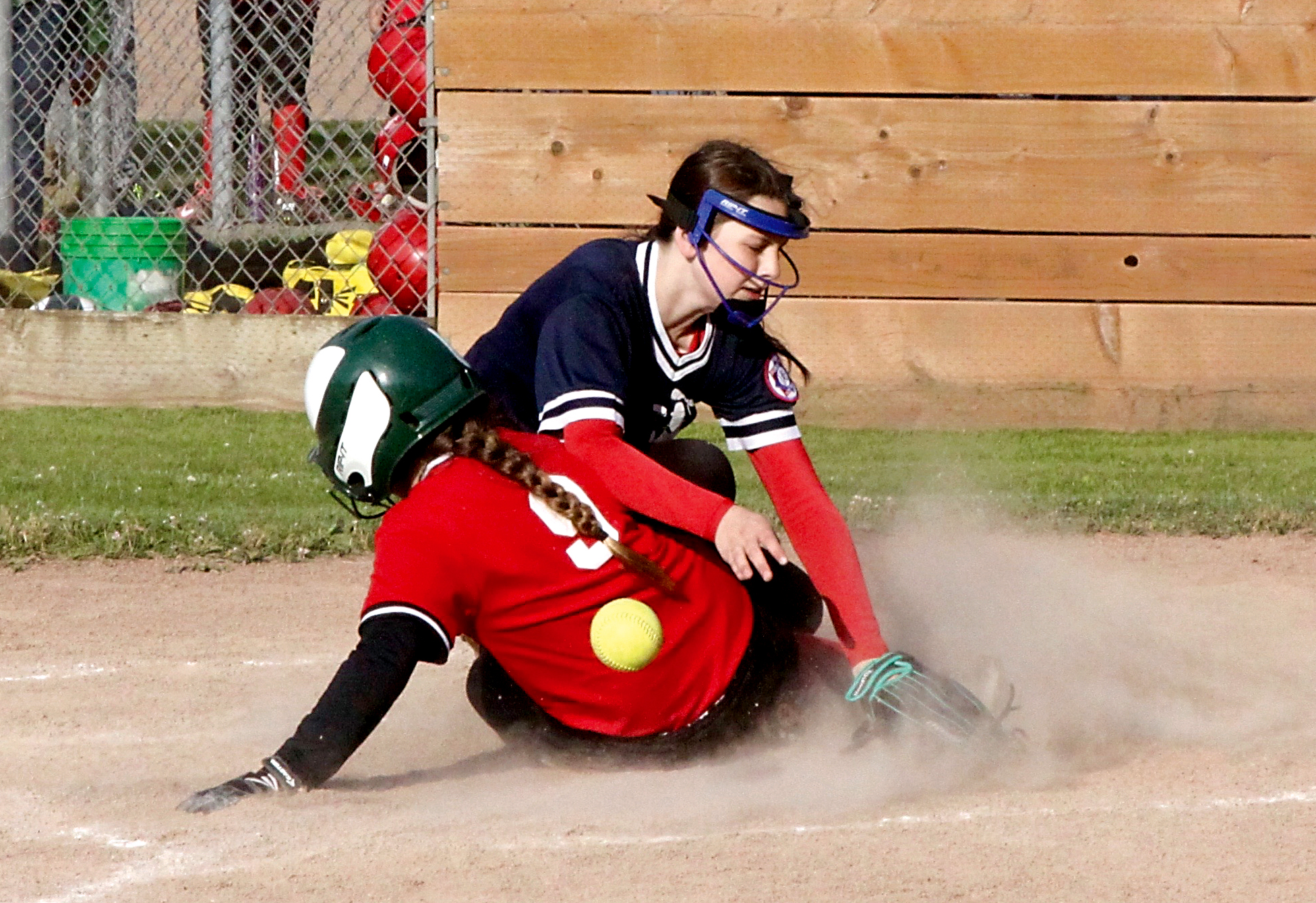 Jim's Pharmacy's Taylor Worthington slides into home as a throw bounces away from Paint and Carpet Barn pitcher Destiny Smith in the 12U softball city championship game at Lincoln Park in Port Angeles. Paint and Carpet won 14-2. (Dave Logan/for Peninsula Daily News)