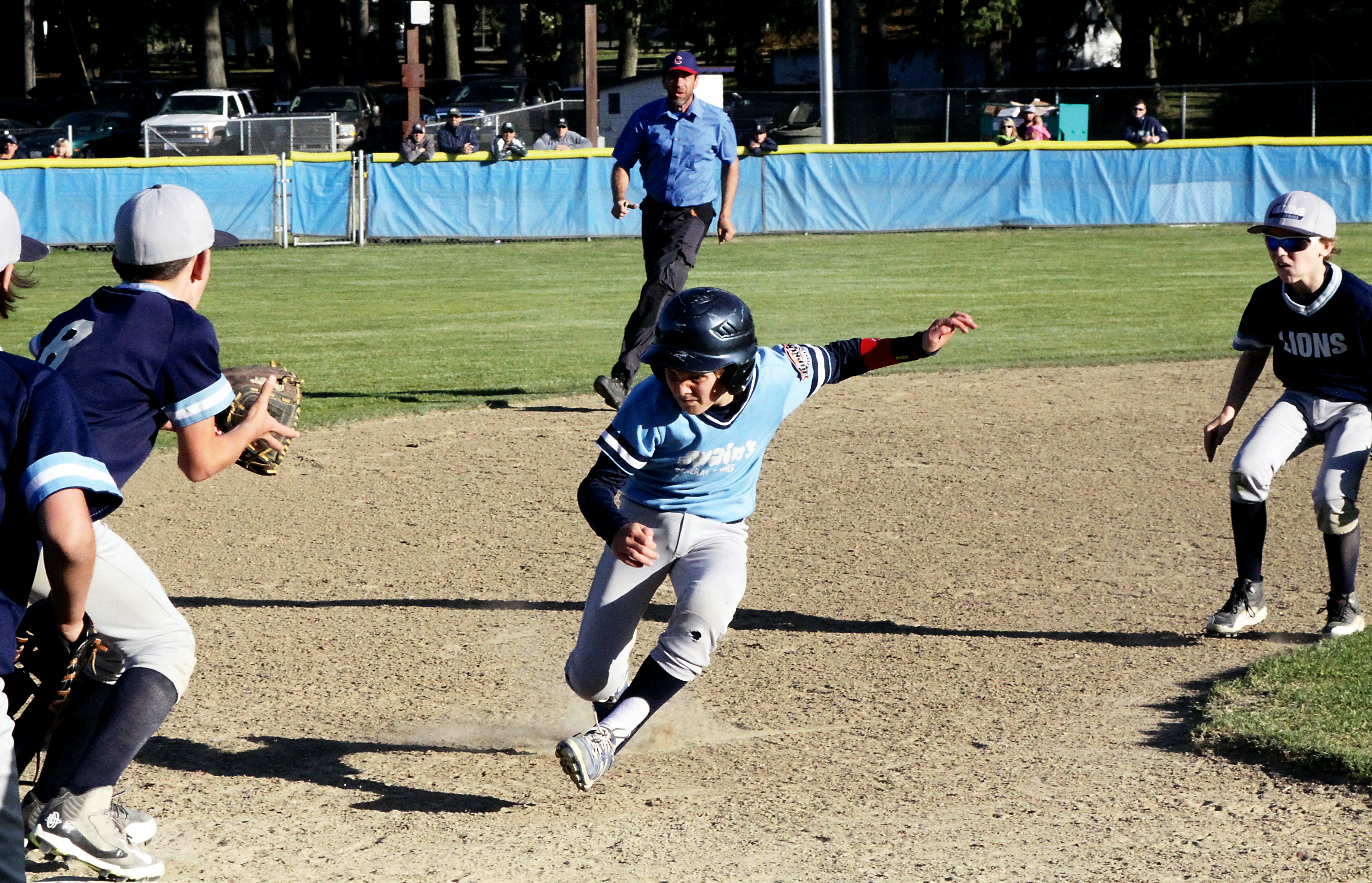 Matt Mangano of Swain's gets caught in a pickle between Lions' Daniel Cable (8) and Dru Clark