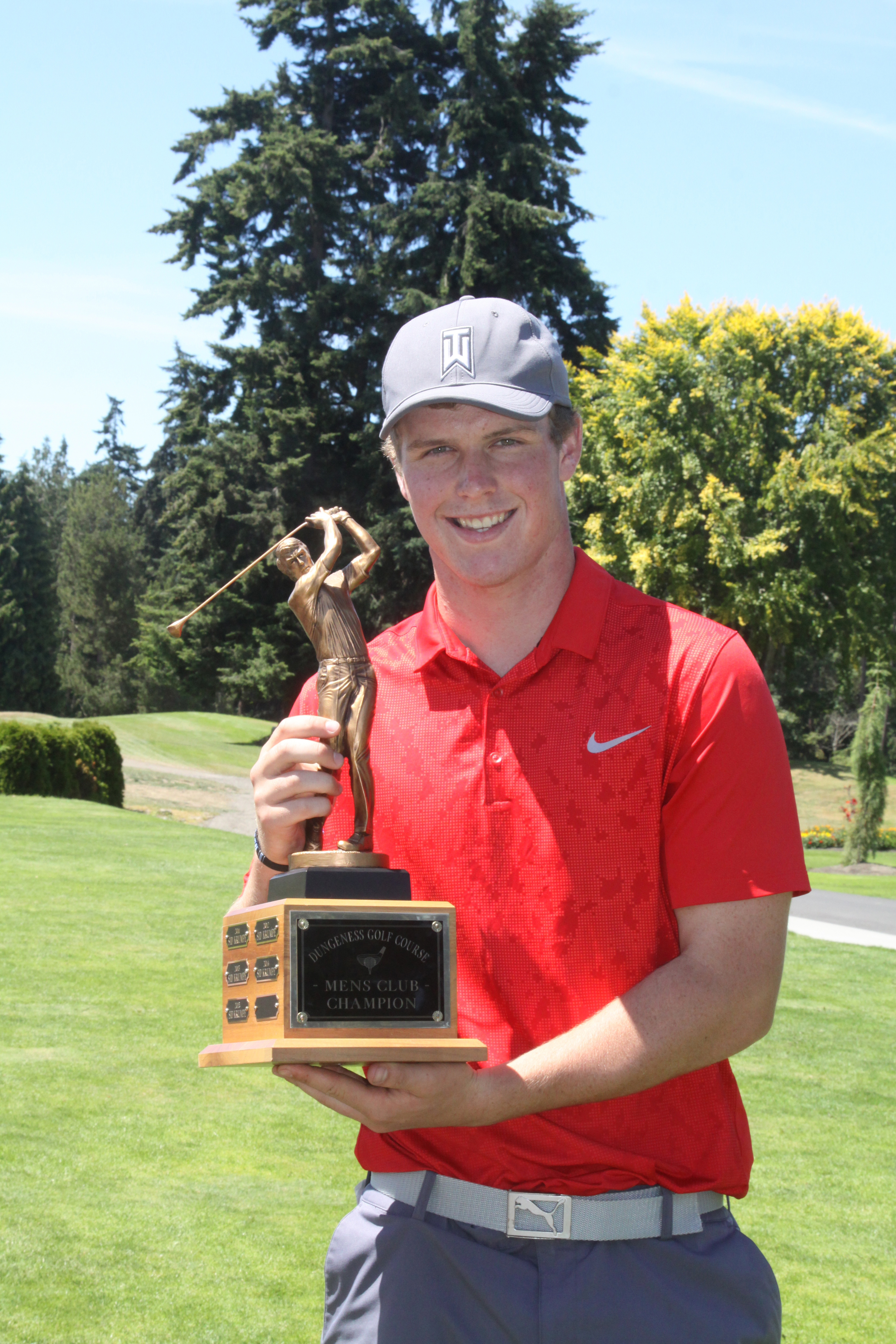 Sequim's Jack Shea holds the Clallam County Amateur Championship trophy after rallying to win the golf tournament by one stroke with a round of 5-under-par 67 at Cedars at Dungeness Golf Course in Sequim on Sunday. (Dave Logan/for Peninsula Daily News)