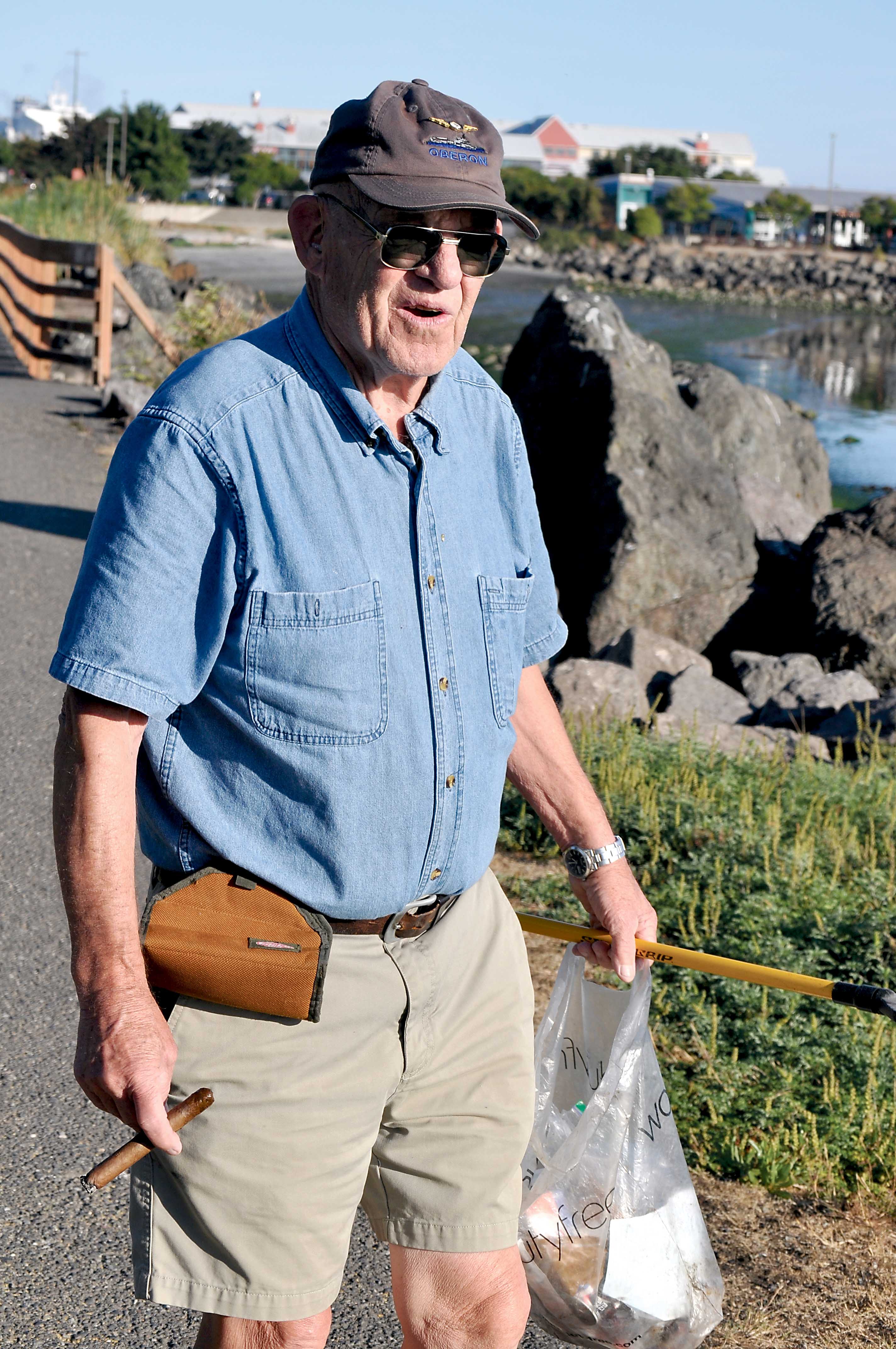Julian McCabe treks the Waterfront Trail snatching litter from the landscape. James Casey/Peninsula Daily News