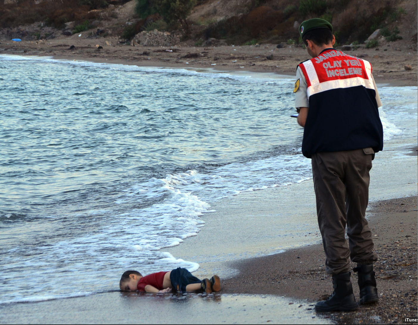 A Turkish paramilitary police officer prepares to carry the body of Aylan Kurdi
