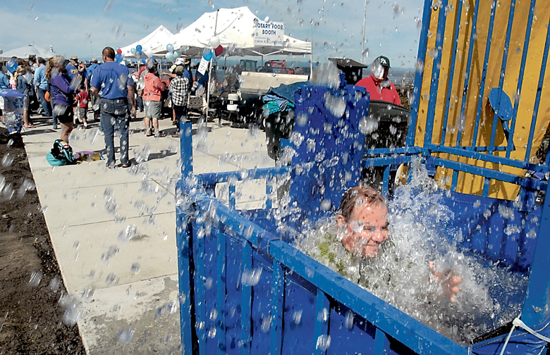 Clallam County Commissioner Jim McEntire falls into the water at a dunking booth set up on the new West End Park on the Port Angeles waterfront during Saturday's grand opening. Keith Thorpe/Peninsula Daily News