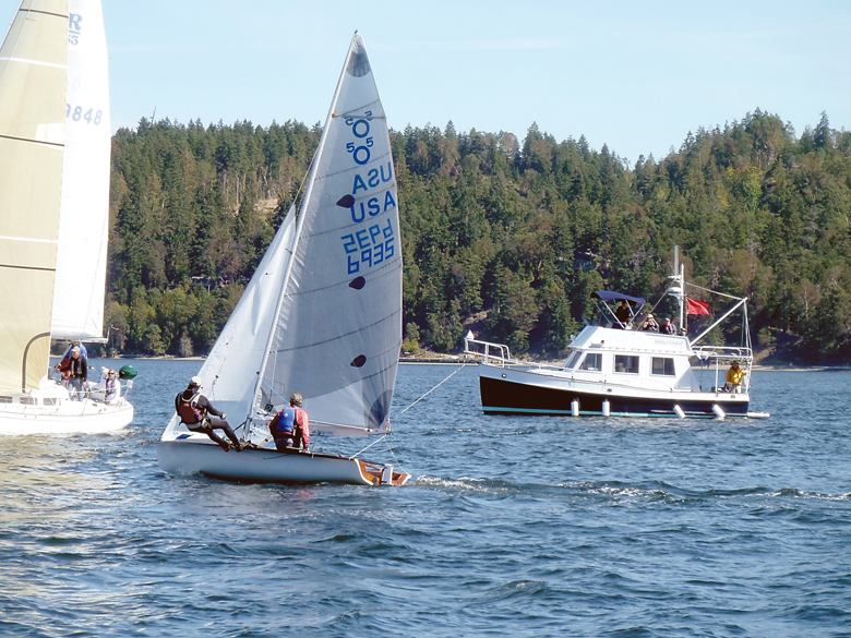 A small boat crew takes off from the starting line in a 2014 Reach for Hospice race. Sequim Bay Yacht Club