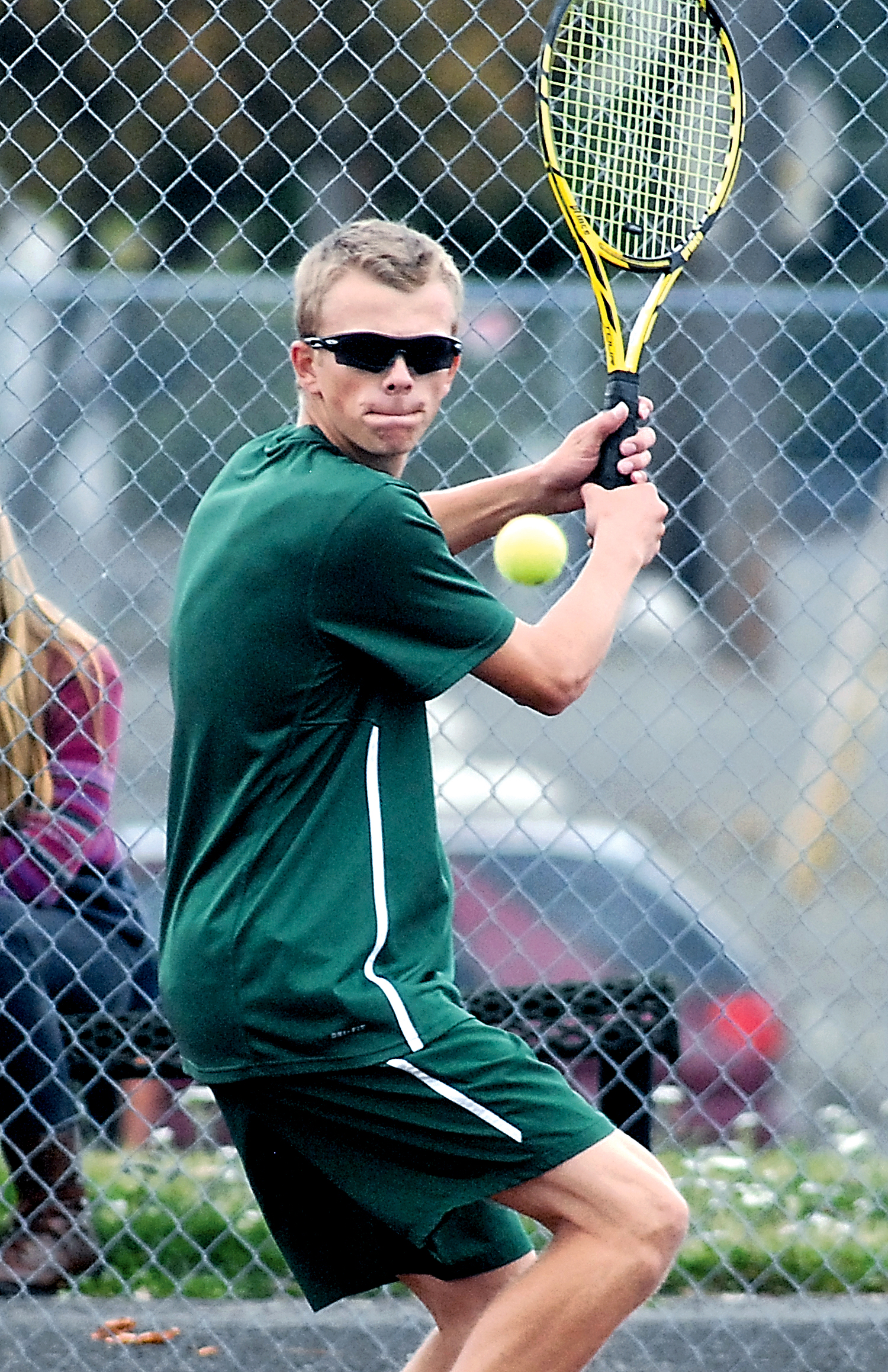 Port Angeles' Janson Pederson hits to Klahowya's Taylor Fite in singles play. Keith Thorpe/Peninsula Daily News