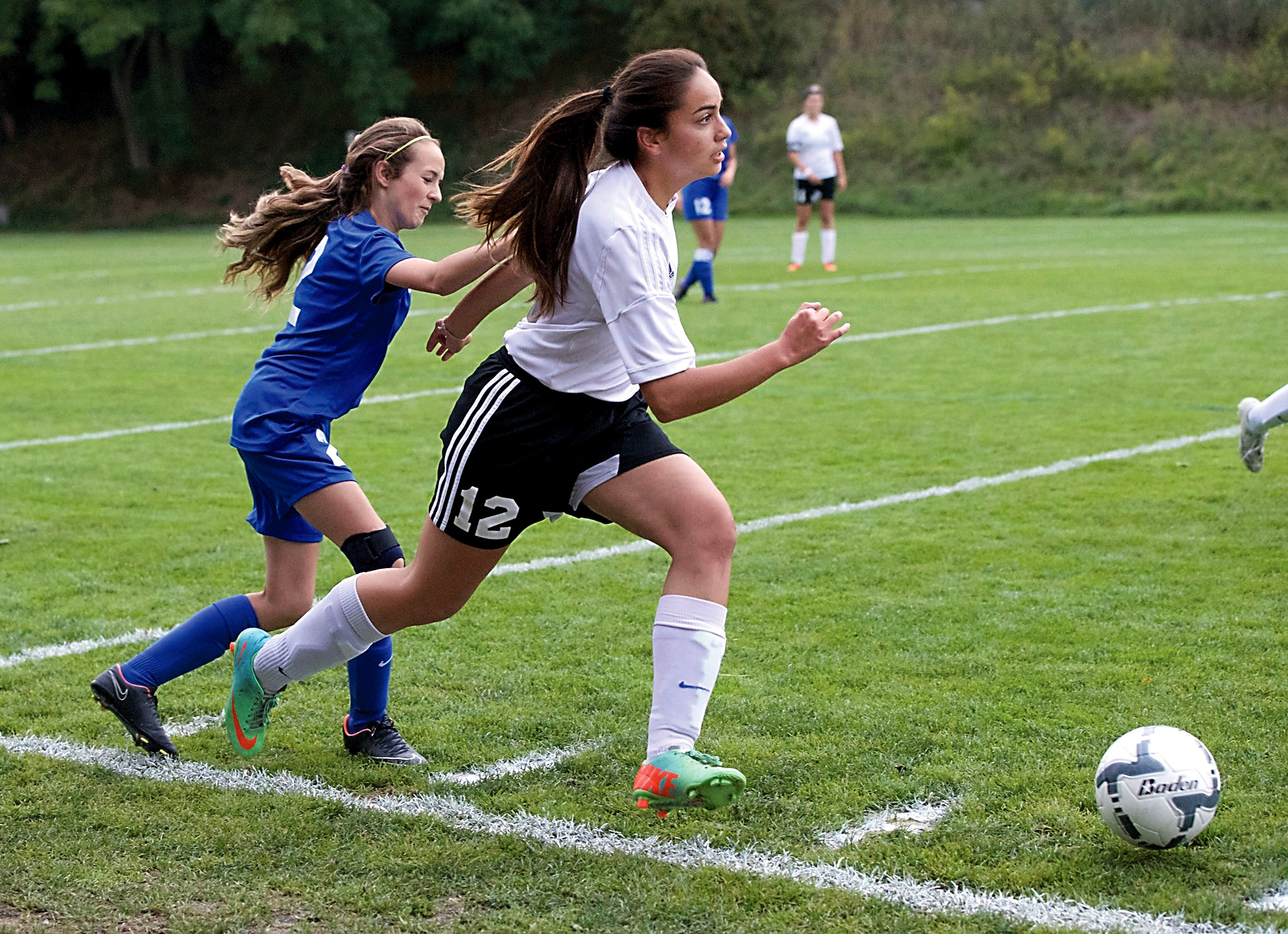 Port Townsend's Eileen Leoso (12) beats Bremerton's Lucille Halloway to the ball at Memorial Field in Port Townsend on Thursday. Steve Mullensky/for Peninsula Daily News