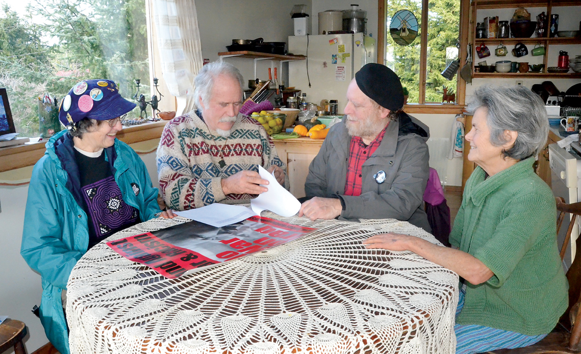 A group meets Thursday to make last-minute plans for today's Peace Walk: from left