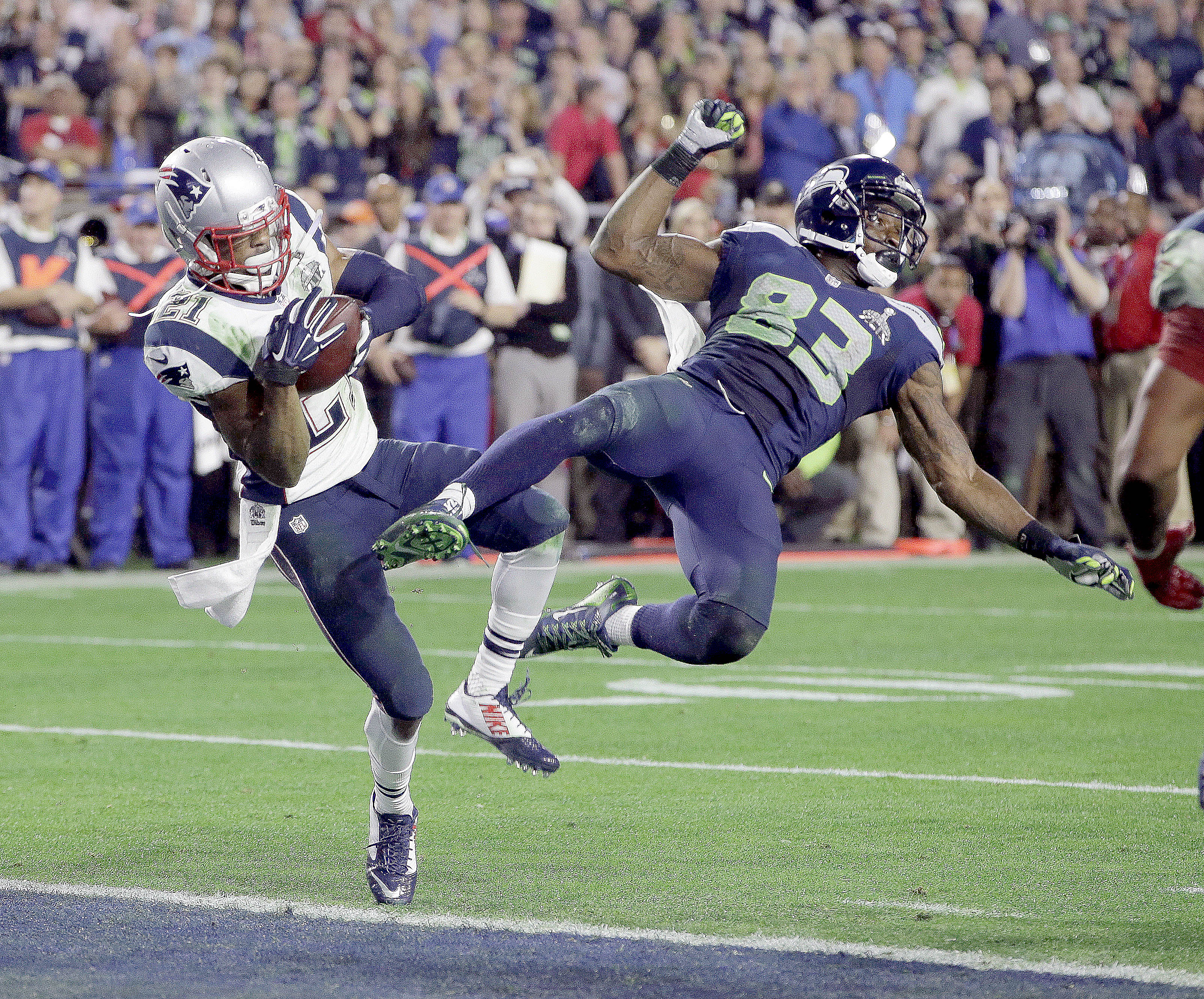 New England Patriots strong safety Malcolm Butler (21) intercepts a pass intended for Seattle Seahawks wide receiver Ricardo Lockette (83) during the final two minutes of Super Bowl XLIX football game. —Photo by The Associated Press ()