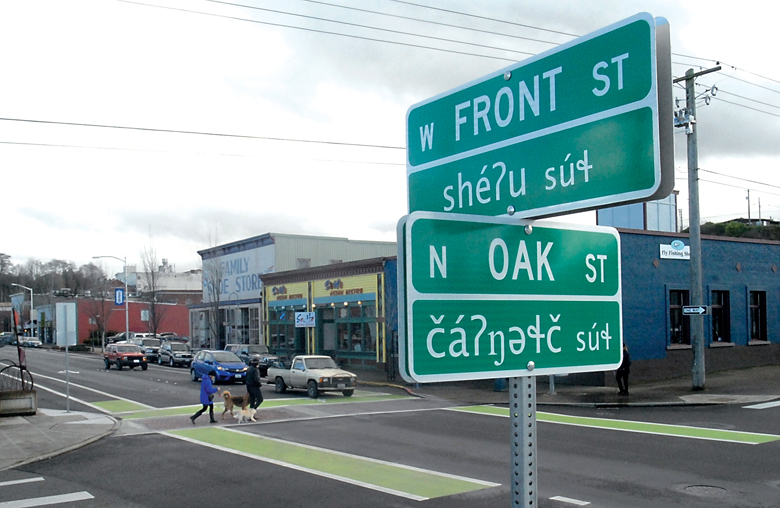 A newly installed street identification sign at Front and Oak streets in downtown Port Angeles indicates the location in both the English and Klallam languages. — Keith Thorpe/Peninsula Daily News ()