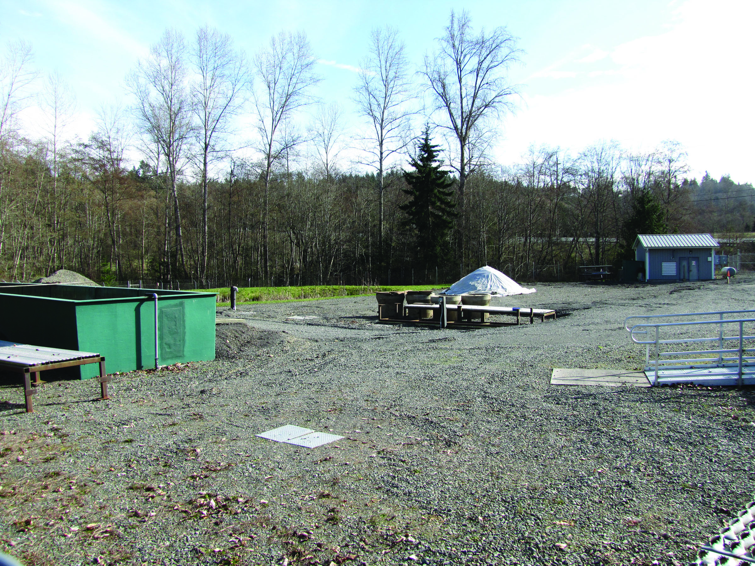 A mobile office and some equipment remain at the state Fish and Wildlife fish-rearing facility at Morse Creek. The primary fish rearing ponds have been removed. (Arwyn Rice/Peninsula Daily News)