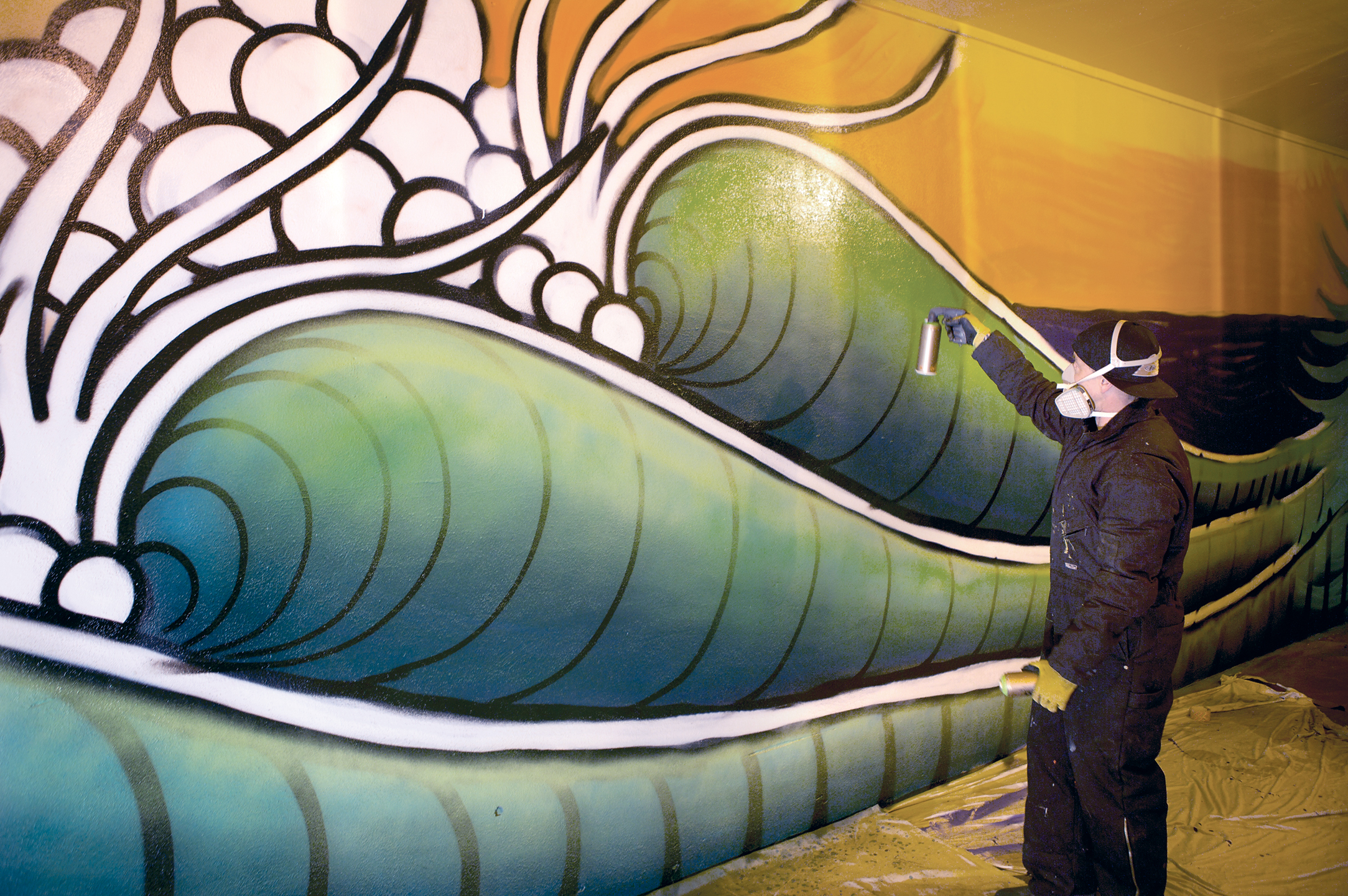 Jamie Lynn works on his new mural in downtown Port Angeles. (Scott Sullivan)