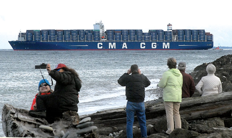 The London-flagged container ship Benjamin Franklin passes by Ediz Hook in Port Angeles as ship watchers