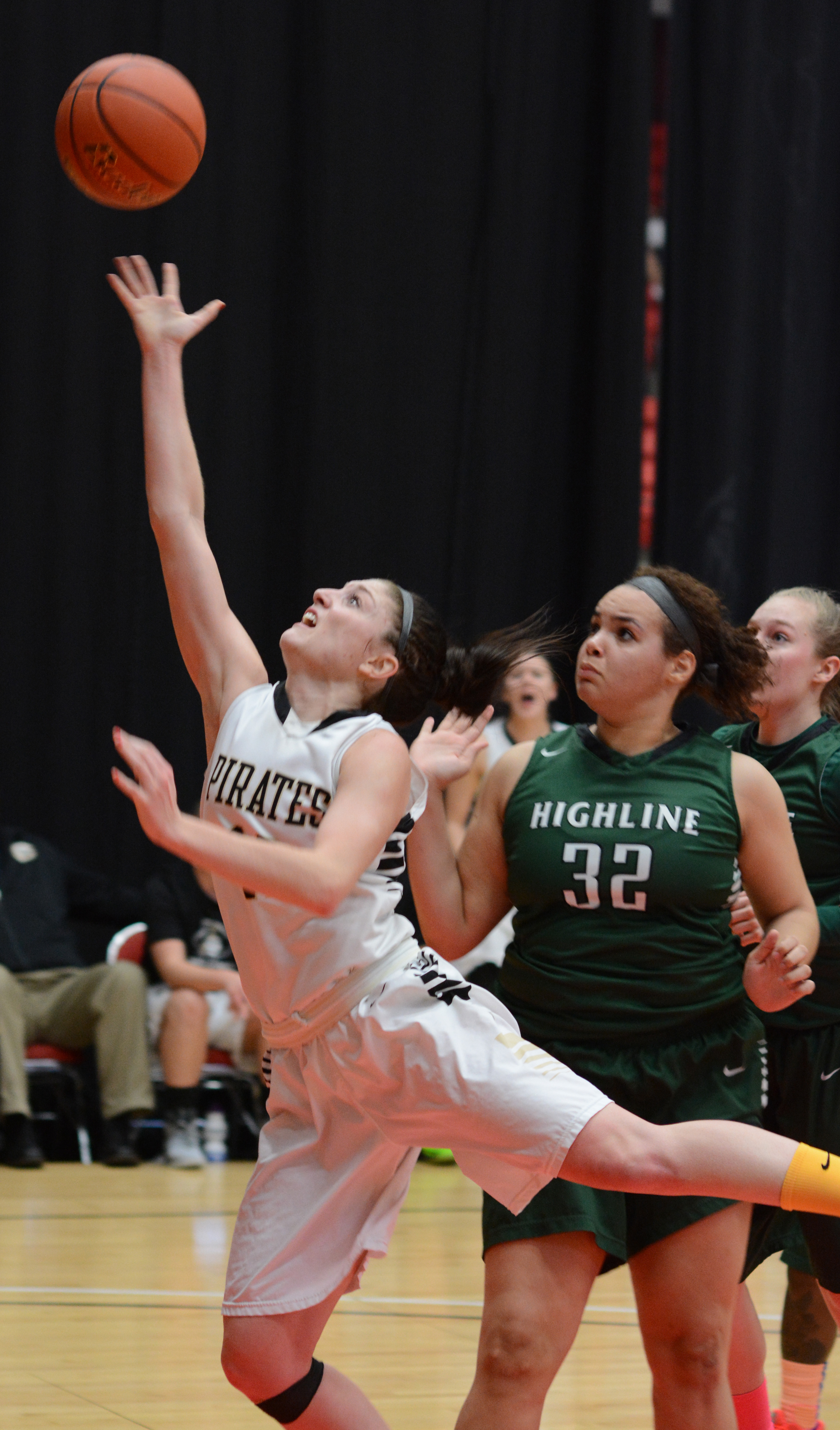 Peninsula's Madison Pilster puts up a layup in front of the defense of Highline's Ionna Price during the NWAC tournament. (Rick Ross/Peninsula College)