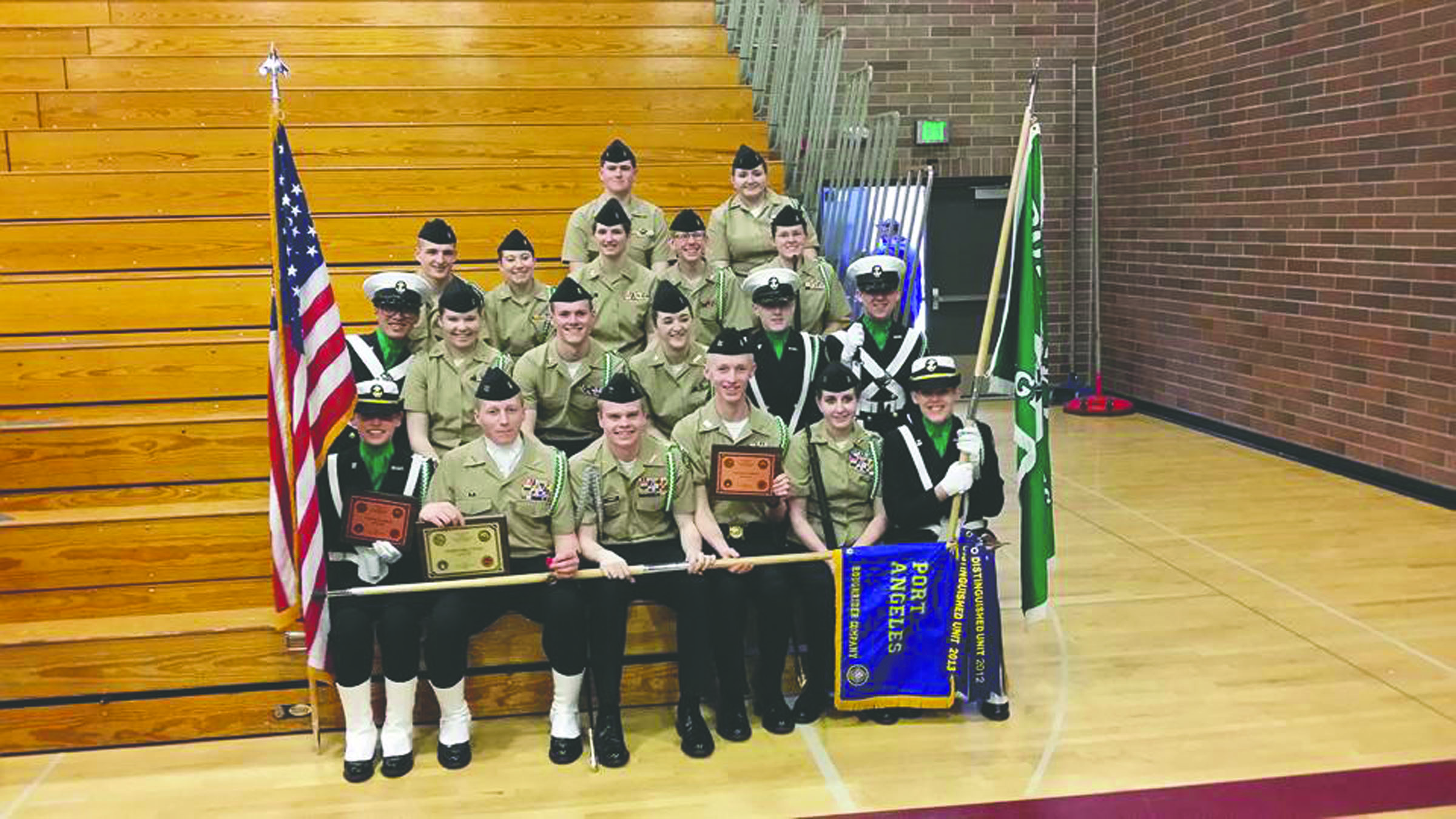 Port Angeles High School NJROTC members display the regional championship plaque they earned in armed drill