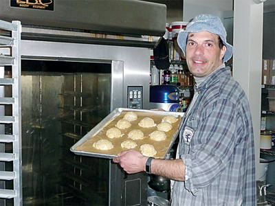Baker Russ Lewis of Bell Street Bakery in Sequim displays a tray of lavender snickerdoodles. (Patricia Morrison Coate/Olympic Peninsula News Group)
