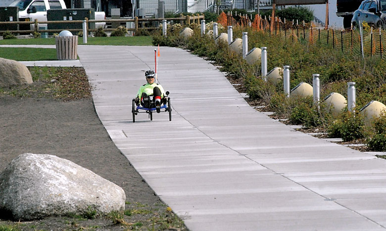 Bob Coates of Port Angeles pedals along a section of the Waterfront Trail through the new West End Park in downtown Port Angeles on Thursday. — Keith Thorpe/Peninsula Daily News ()
