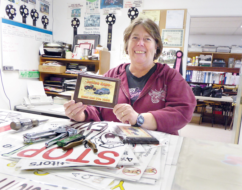 Sue McIntire displays one of the car trophies to be awarded at this weekend's Jeffco Expo. (Charlie Bermant/Peninsula Daily News)