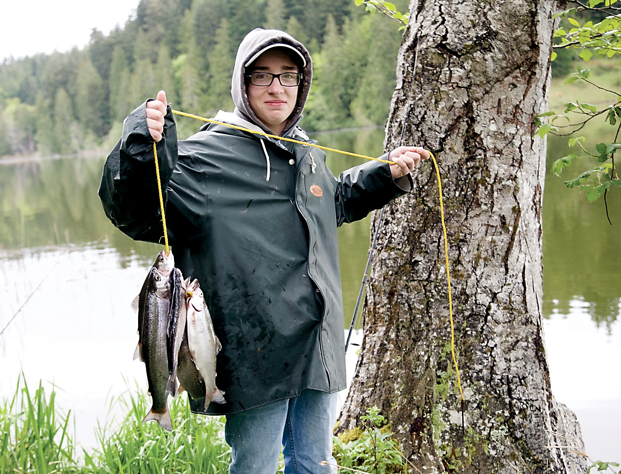 Christopher DeAscentiis of Hansville shows off the six trout he caught in the first hour of opening day for fishing Saturday at Anderson Lake in Chimacum. —Photo by Steve Mullensky/for Peninsula Daily News ()