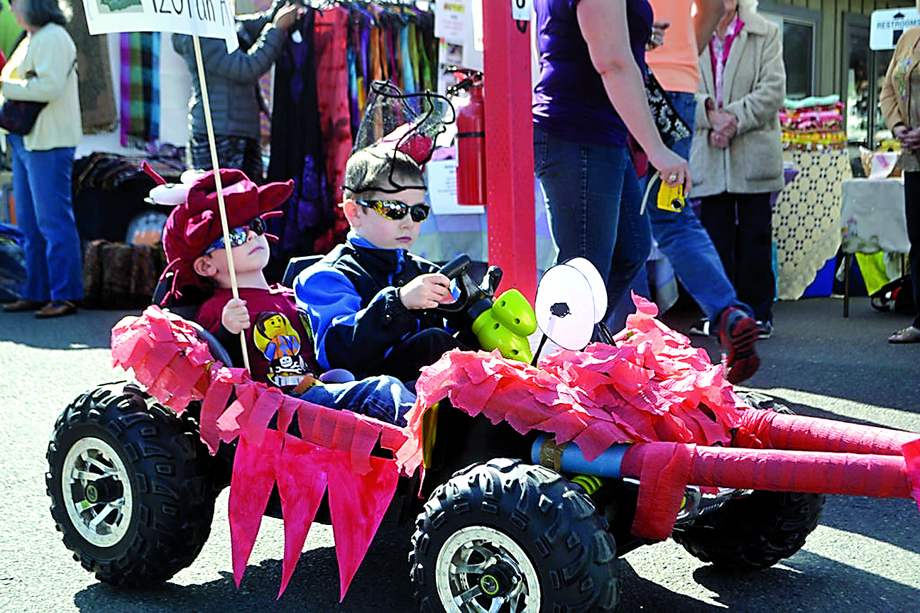 Patrick and Ronan Clark roll down Washington Street in style sporting a crab theme for the 2015 Kids Parade during the Sequim Irrigation Festival. (Matthew Nash/Olympic Peninsula News Group)