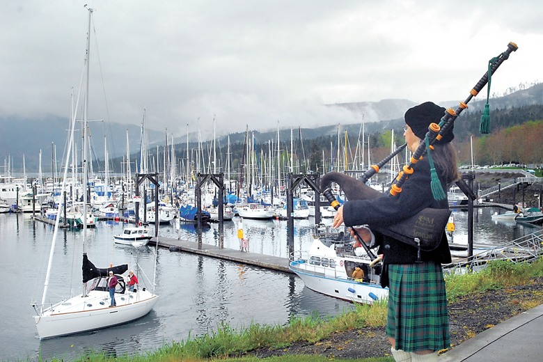 Bagpiper Nancy Fredrick of Port Townsend plays from the point overlooking the entrance to John Wayne Marina in Sequim to celebrate the opening day of boating season several years ago. This year's bagpiper will be Thomas McCurdy. (Keith Thorpe/Peninsula Daily News)