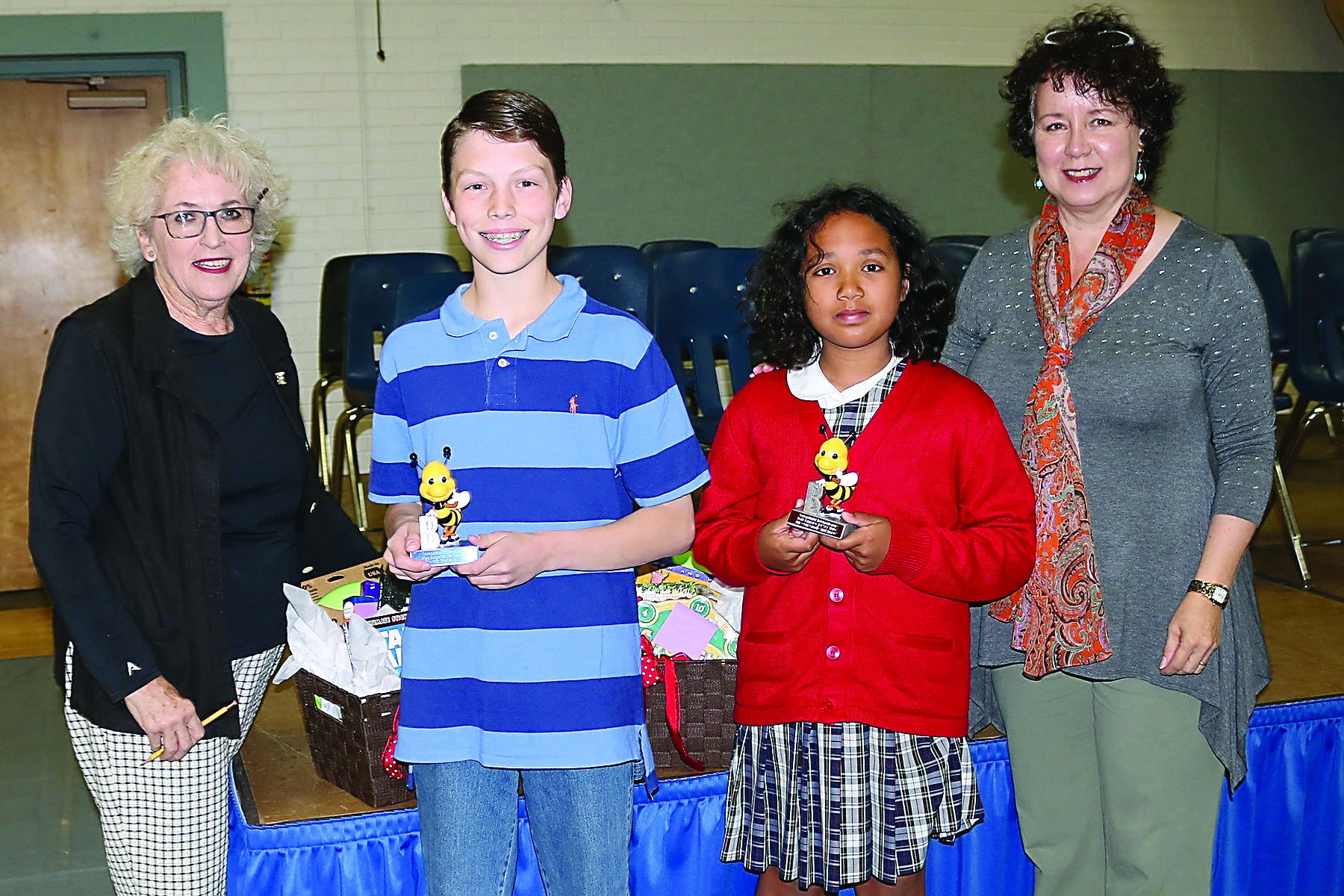 Port Angeles Elementary School spelling bee winners stand with Soroptimist Jet Set bee organizers. From left are