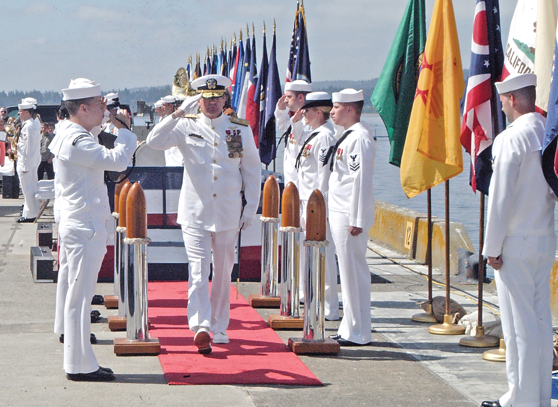 Rear Adm. Jeff Ruth salutes following the change-of-command ceremony Thursday at Naval Magazine Indian Island. (Chris McDaniel/Peninsula Daily News)