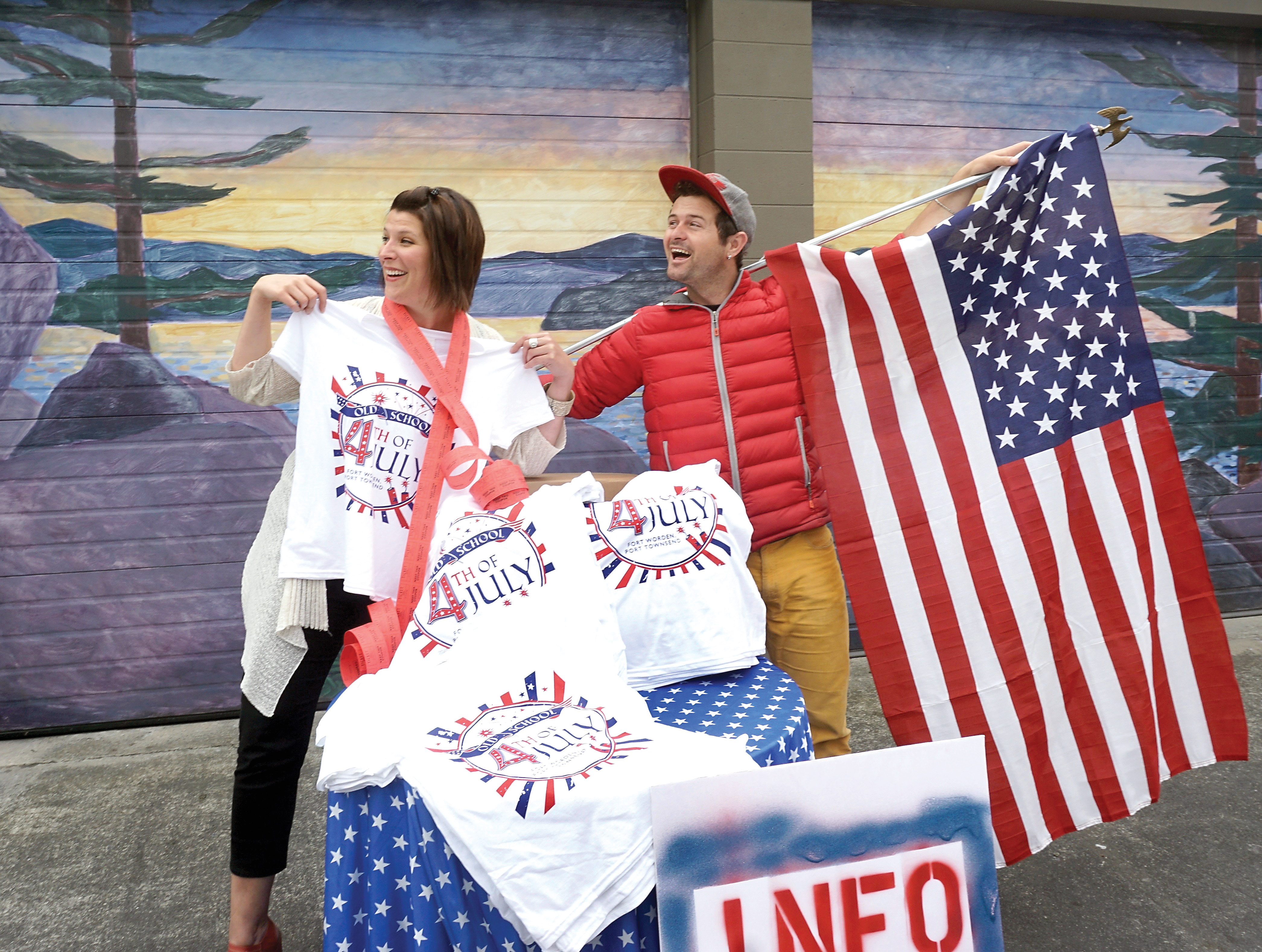 Jefferson County Chamber of Commerce Executive Director Teresa Verraes and event planner Danny Milholland sort through some of the items that will be sold at Monday's Fourth of July gathering. (Charlie Bermant/Peninsula Daily News)