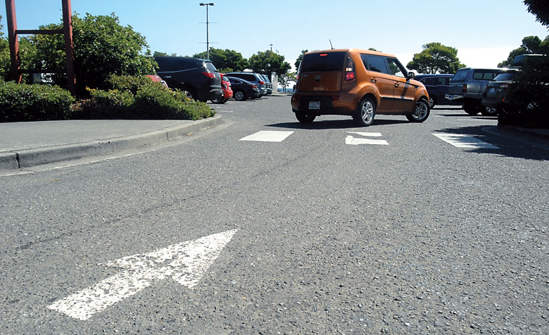A car backs out of a parking space in the lot at Port Angeles City Pier on Wednesday. Public concerns about parking have prompted a rethinking of pier redesign plans. (Keith Thorpe/Peninsula Daily News)