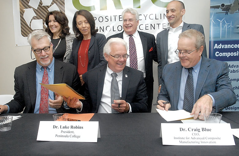 Participants in the signing of a memorandum of understanding to formally begin operations at the newly built Composite Recycling Technology Center in Port Angeles share a moment of levity Friday. Signing the agreement were