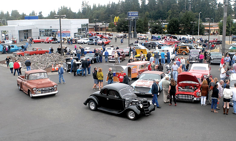 Vintage cars make their way through the lot at Ruddell Auto Plaza in Port Angeles at the beginning of last year's Ruddell Cruise-In. (Keith Thorpe/Peninsula Daily News)