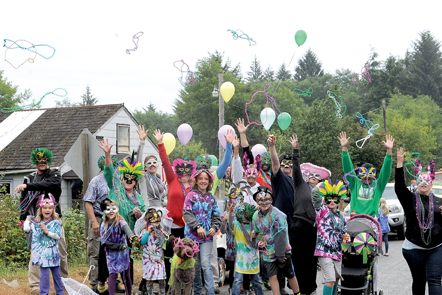 This large group of individuals sporting colorful attire is the Mardi Gras entry to last year's Clallam Bay-Sekiu Fun Days parade. (Lonnie Archibald/for Peninsula Daily News)