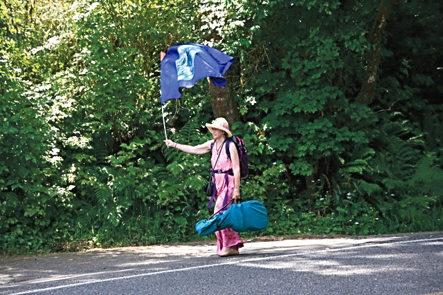 Sallie Spirit Harrison walks along U.S. Highway 101 on her way to Lake Quinault.