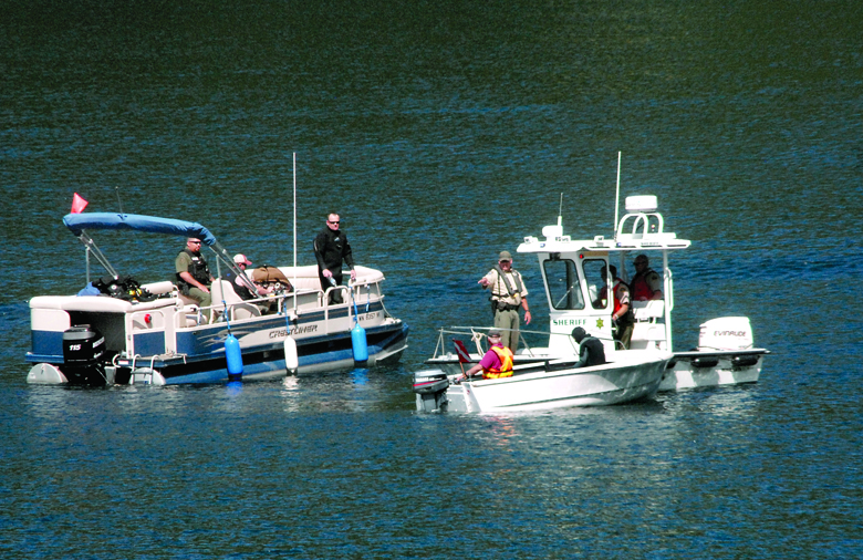 Rescue boats and a Clallam County Sheriff's Office vessel are joined by a dive boat in the search for a person reportedly drowned Friday in Lake Sutherland west of Port Angeles. (Keith Thorpe/Peninsula Daily News)