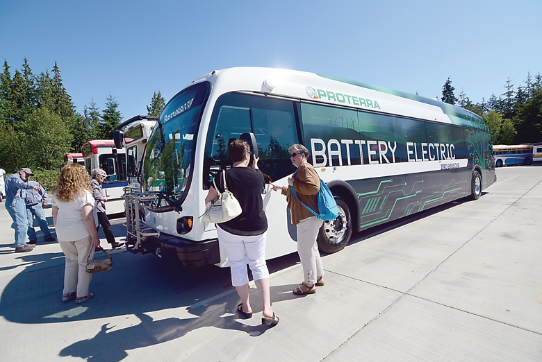 Jefferson County Transit Authority officials and board members take a close look at one of Proterra's electric buses on Thursday. Jefferson Transit's goal is to eventually have a full fleet of electric buses. (Jesse Major/Peninsula Daily News)