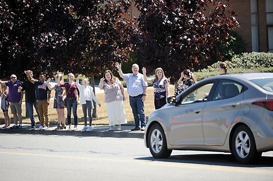A group of Sequim residents gathers in front of the Sequim Church of Jesus Christ of Latter-day Saints on Thursday to wave and honor former Sequim schools traffic attendant Mike Lovejoy at his funeral. (Matthew Nash/Olympic Peninsula News Group)