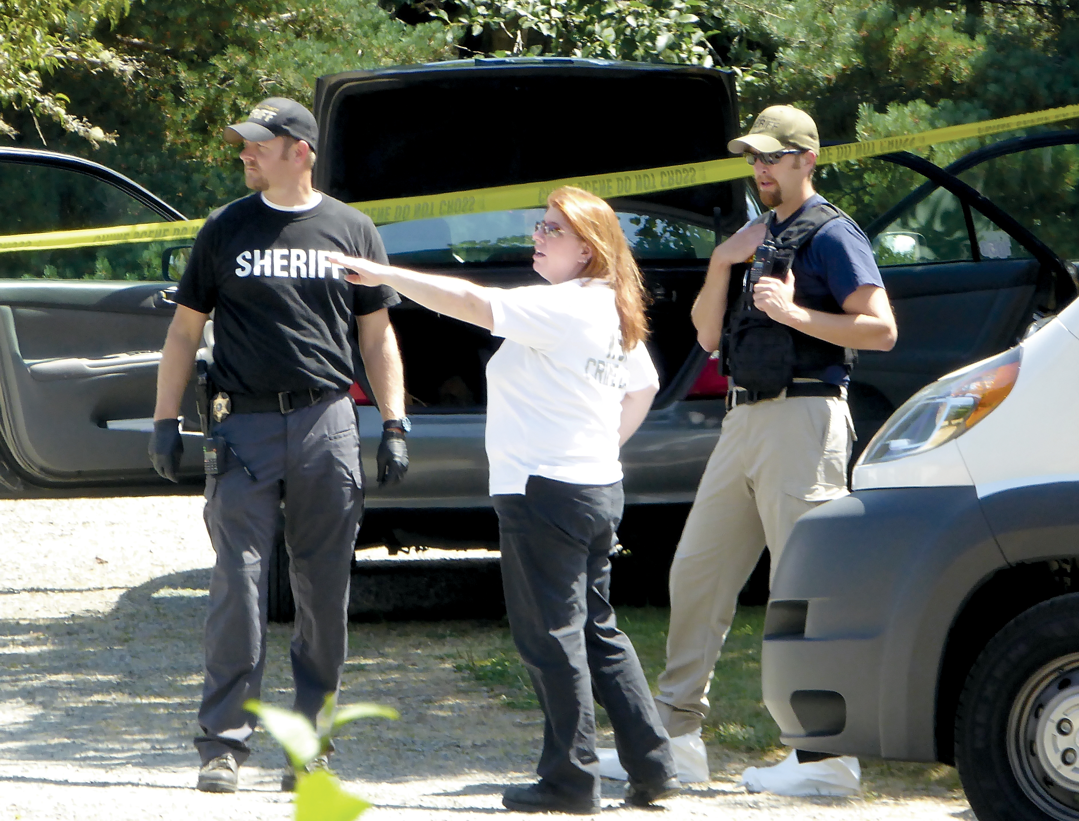 State Patrol forensic scientist Sara Trejo meets with Jefferson County sheriff's Detectives Ryan Menday