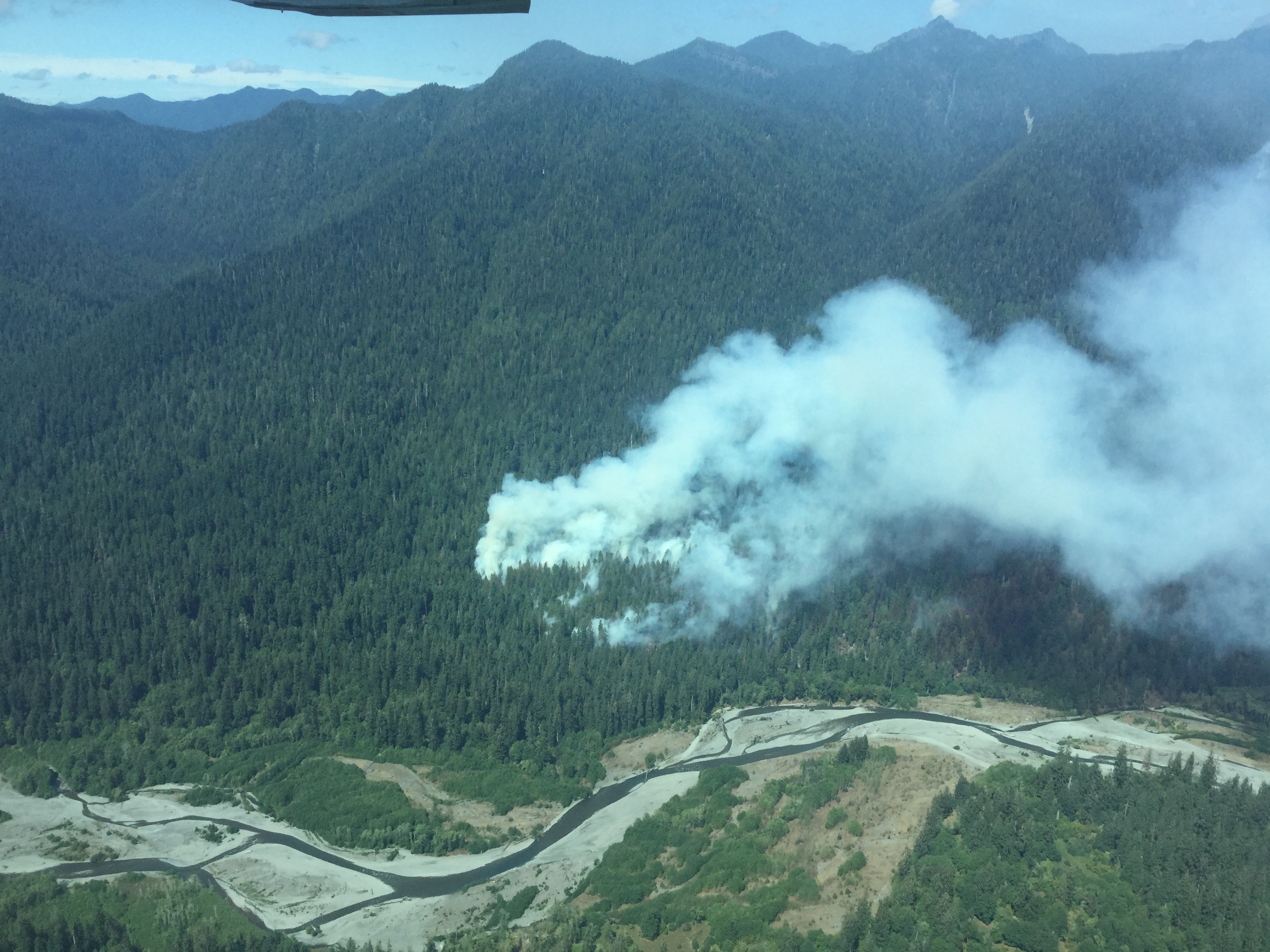 Smoke from the Paradise Fire billows from the forest near the Queets River in Olympic National Park on Monday. The blaze grew by 504 acres over the weekend.  Olympic National Park