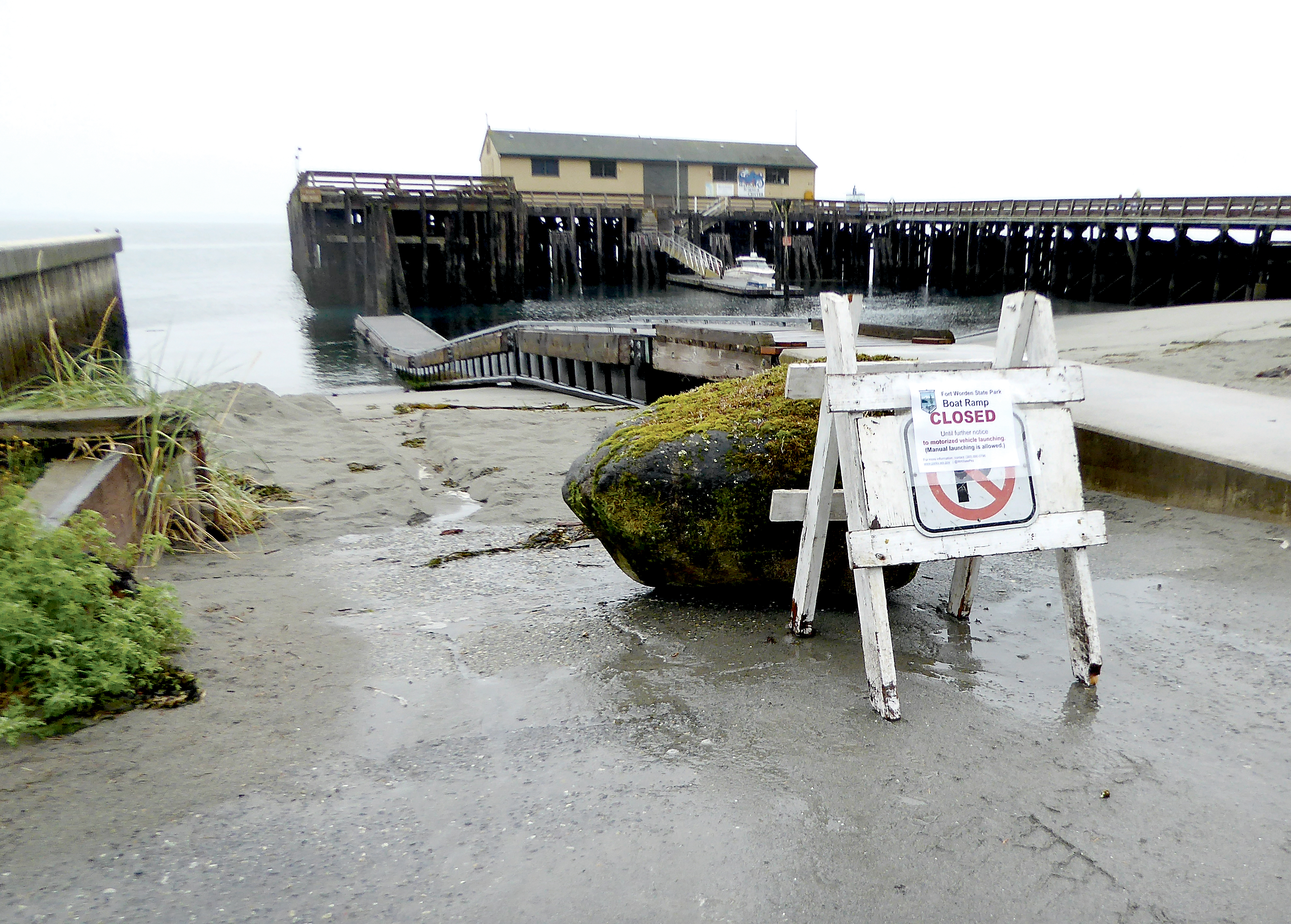 Park personnel moved a boulder in front of the Fort Worden State Park boat ramp to enforce its closure. — Charlie Bermant/Peninsula Daily News
