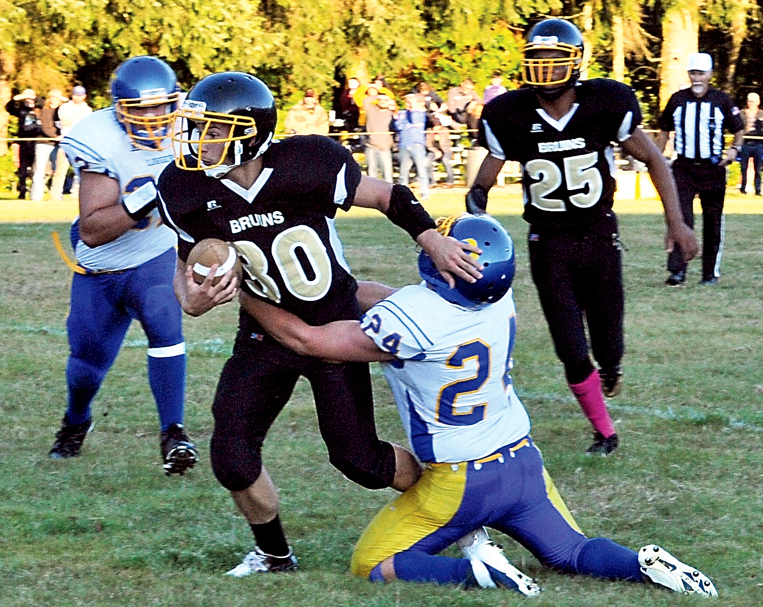 Clallam Bay running back Clayton Willis (30) attempts to escape the defense of Crescent's Wyatt McNeece