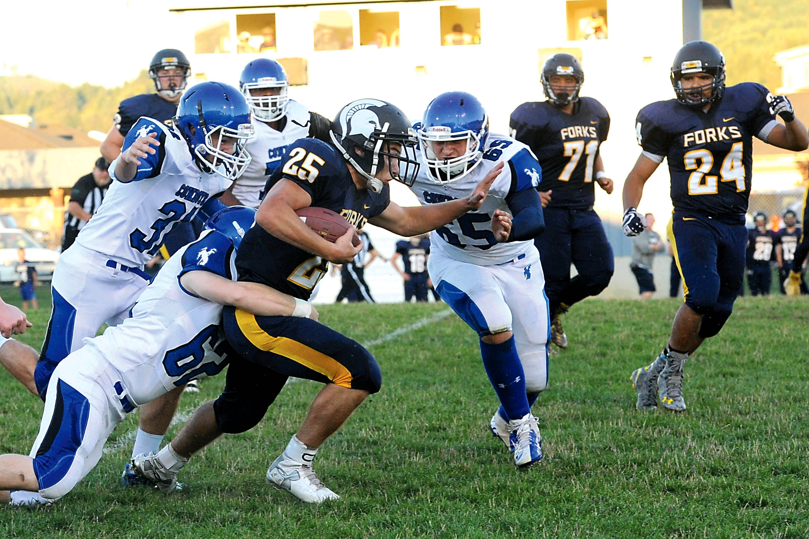 Forks running back Kenny Gale (25) is pursued by Chimacum's Michael Walton (62)